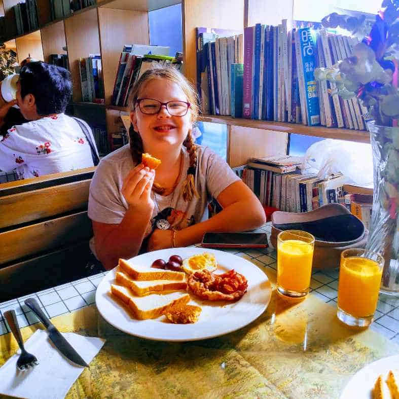 Eating breakfast at a hostel in Xian booking hotels in China