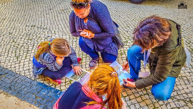 Bec, Willow, Marley and Mariana from Little Lisbon tour for kids are doing the work sheet put together to find the balconies on the fronts of the buildings in Lisbon.
