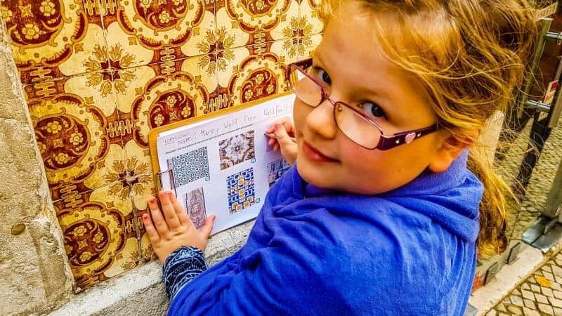 Marley doing her work sheet on a tiles wall while on the Little Lisbon Tour for kids. She has already found 3 sets of the tiles