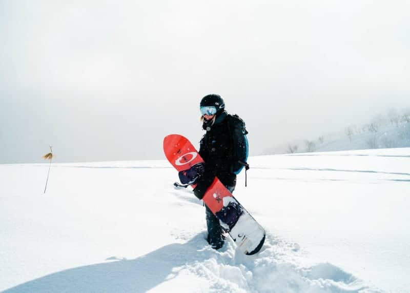 a board rider carrying his snow board in SLC