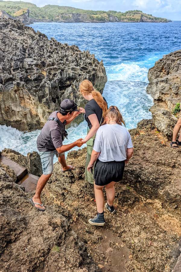 two teenage girls explore the shoreline of Nusa Penida Island near Bali