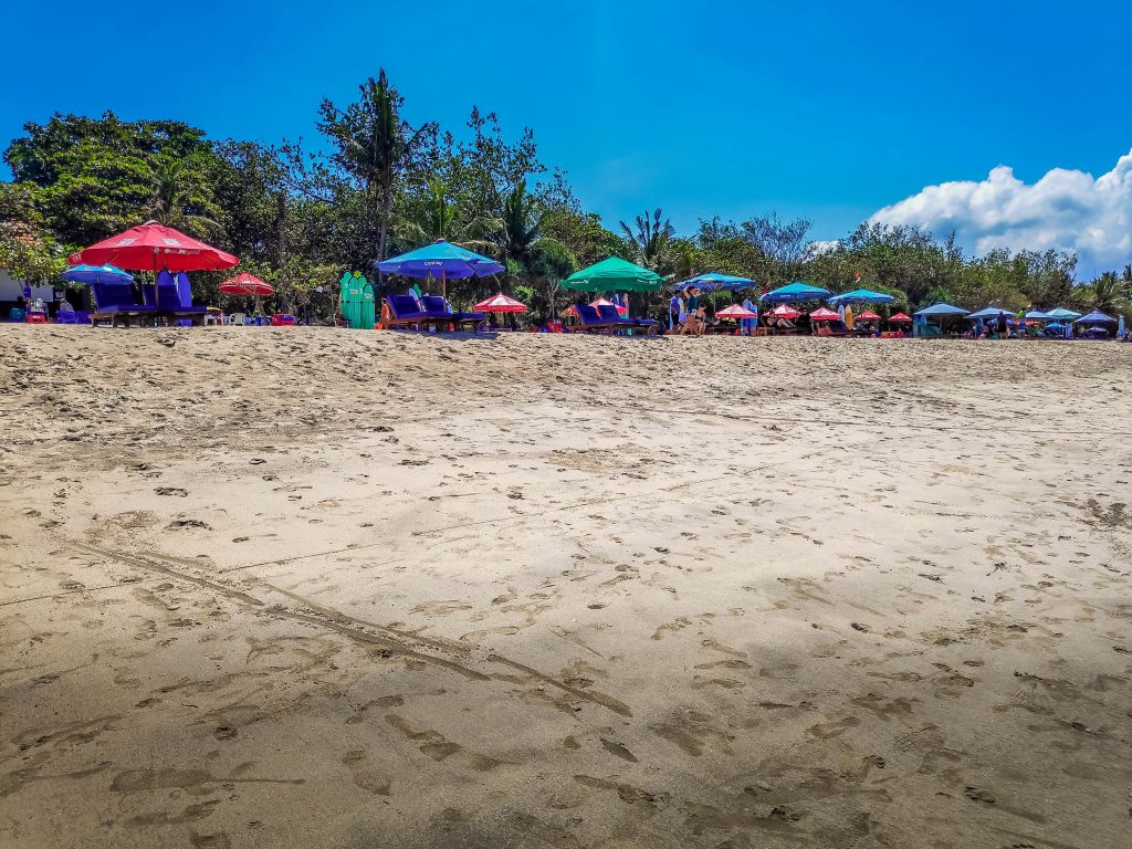 Umberellas line the beach at Kuta