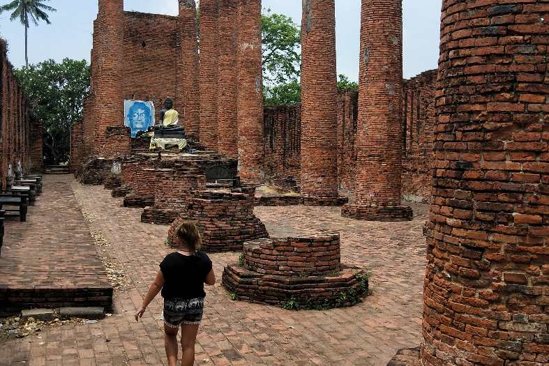 a teenage girl exploring Ayutthaya ruins near Bangkok
