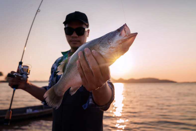 Holding a fish caught near Bangkok
