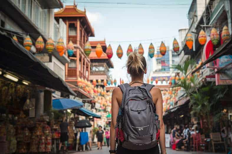 Teenager exploring a bustling street market in Bangkok