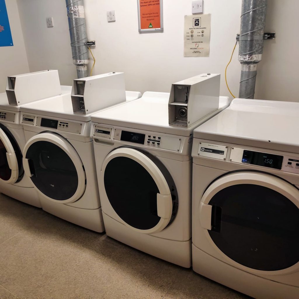Laundry room at Central London YHA with plenty of machines for people to use to get their washing done.