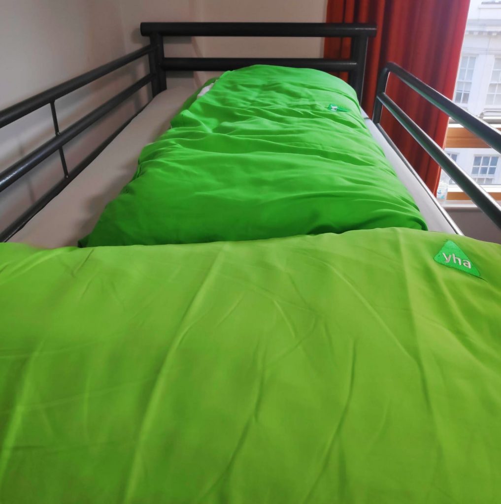 family bedroom at YHA Central London. This is a picture of the top bunk with the signature green bedding that comes in all of the YHA hostels