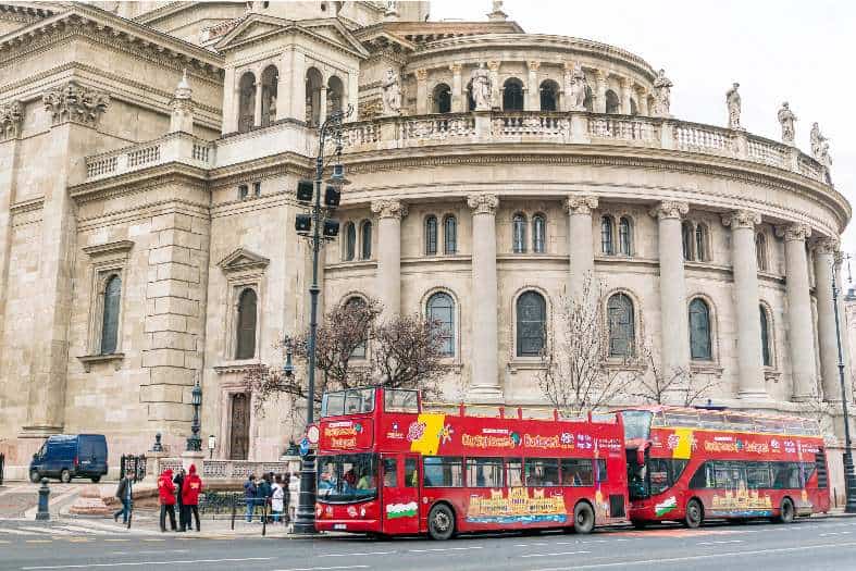 2 red tourist buses parked in Budapest