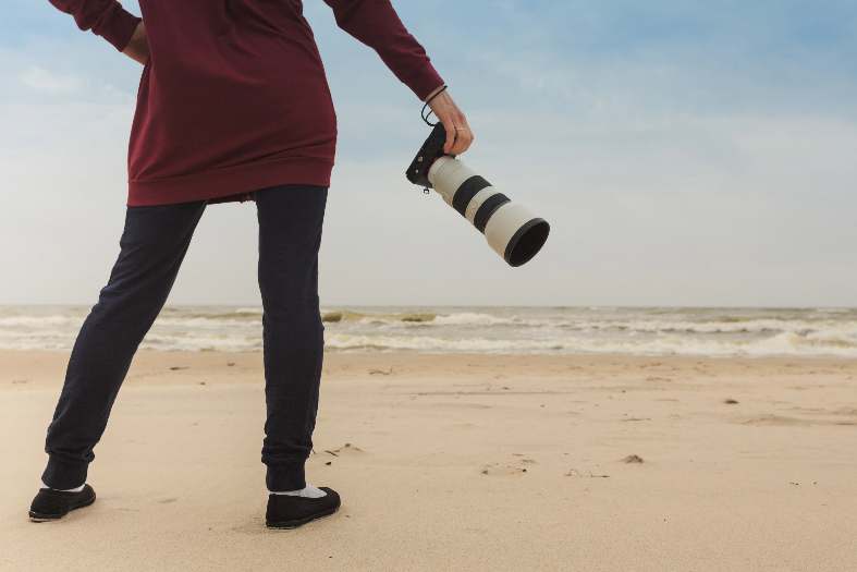 a professional photographer on the beach taking pictures of families on vacation