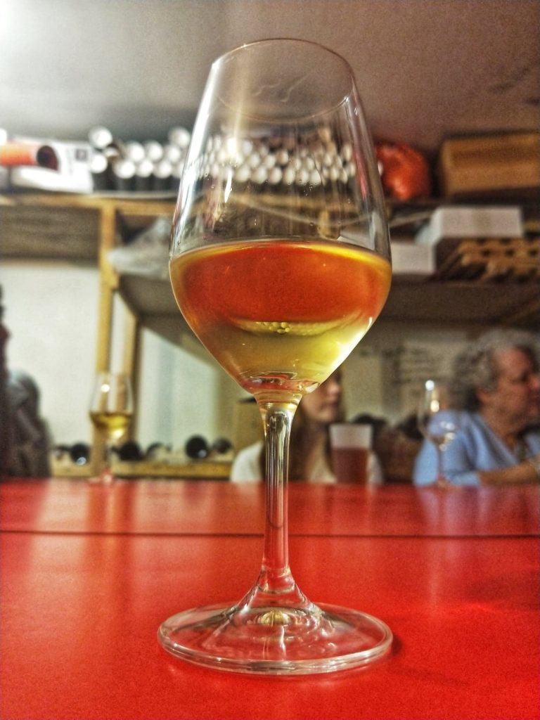a glass of wine on best paris food tours