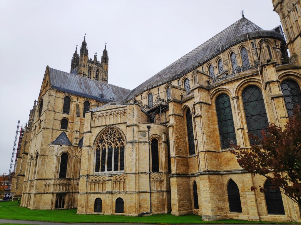 Canterbury Cathedral with its sandstone pillars and stained glass windows. It looks a little dull in the weather as it has been raining