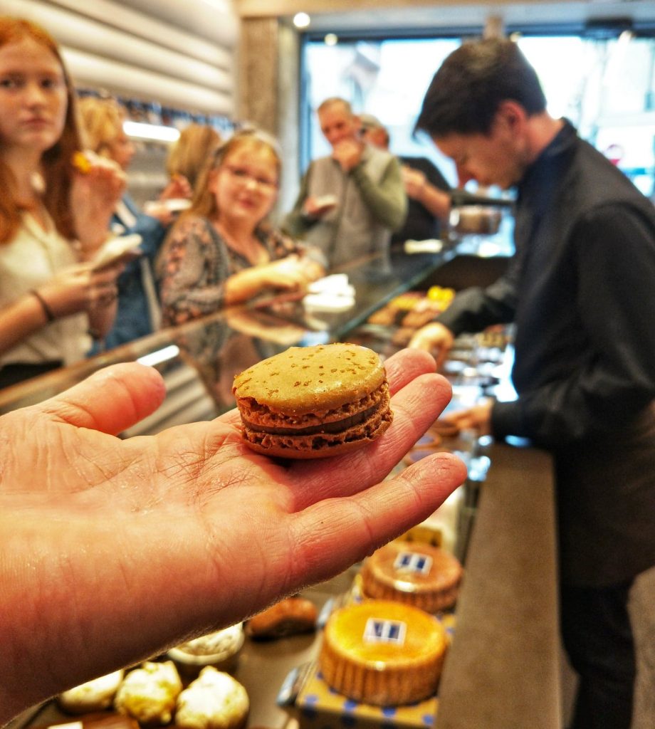 Teenagers on a food tour in Paris lining up for a macaron