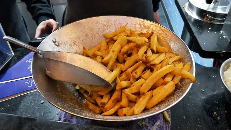 a bowl of fries at mannekenpis in amsterdam waiting to be served