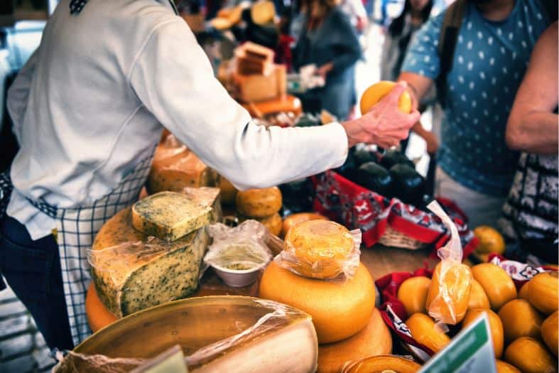 showing tourist some of the dutch food in the market