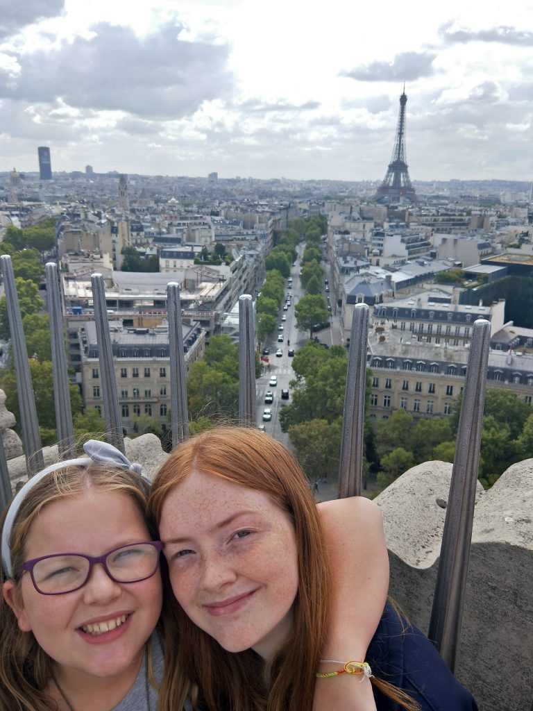 2 teenage girls enjoying the view from the Arc de Triomphe