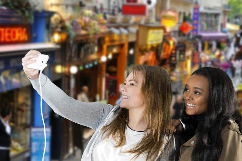 two young adults in Paris atking selfies