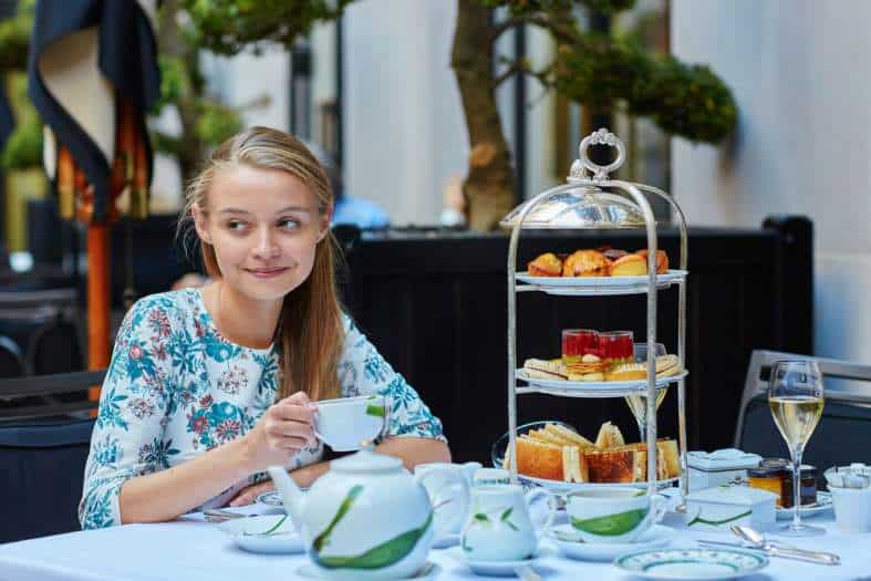 a teenage girl enjoying high tea on a vacation