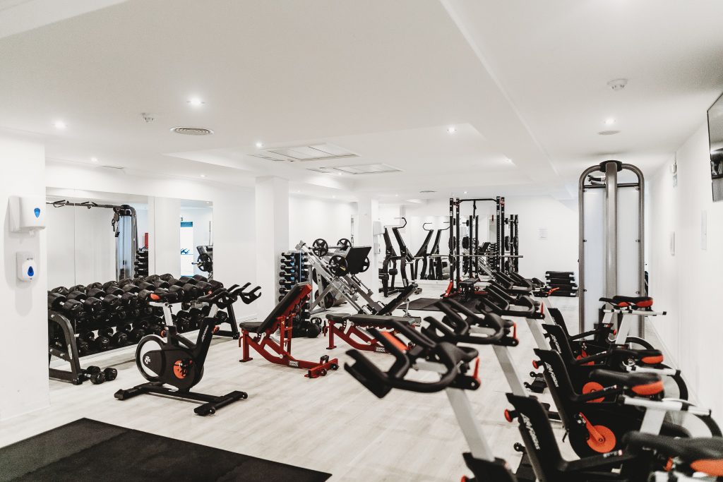 Many teens love to use gym equipment when they are home. This is a room full of gym equipment but there is no one in there.