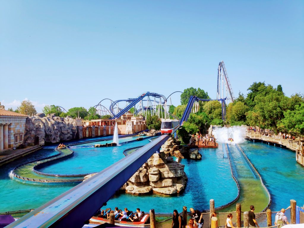 A huge water roller coaster at Europa Park. One of the boats is just hitting the water with a huge splash