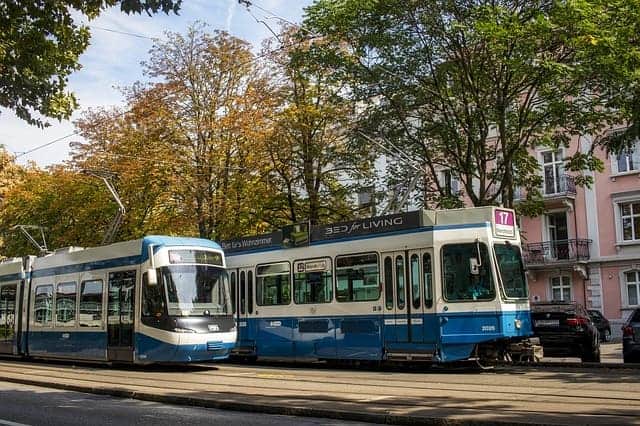 Effortless Urban Elegance with the iconic tram gliding through the heart of Zurich with teenagers