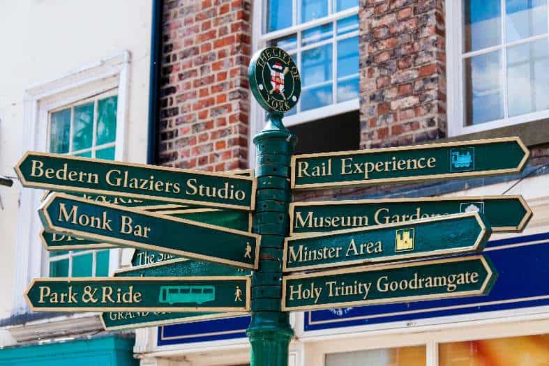 tradition street sign in York Engl;and with directions to attractions