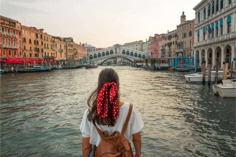 a young adult female exploring the waterways of venice
