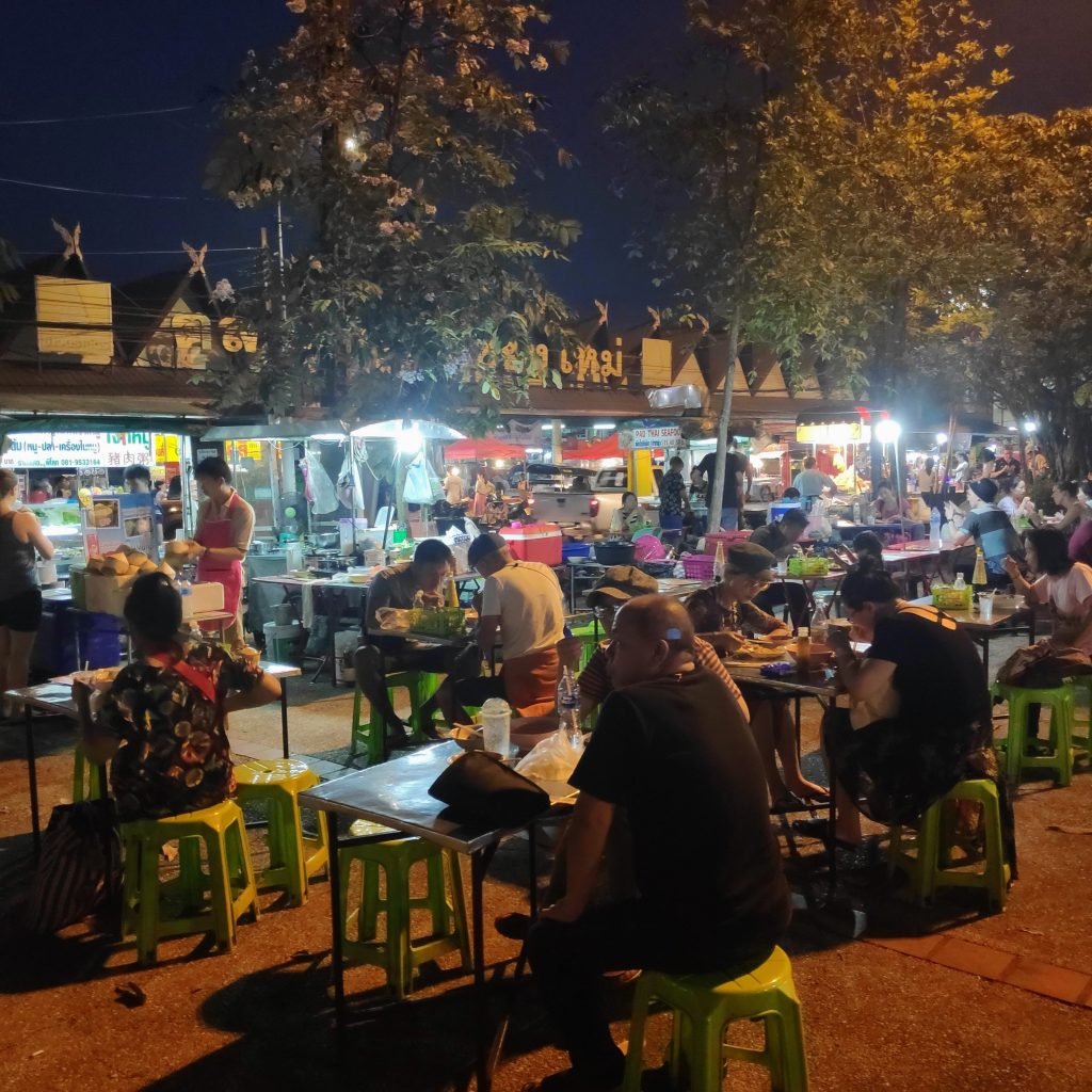 people eating food at the north gate night market in Chiang Mai