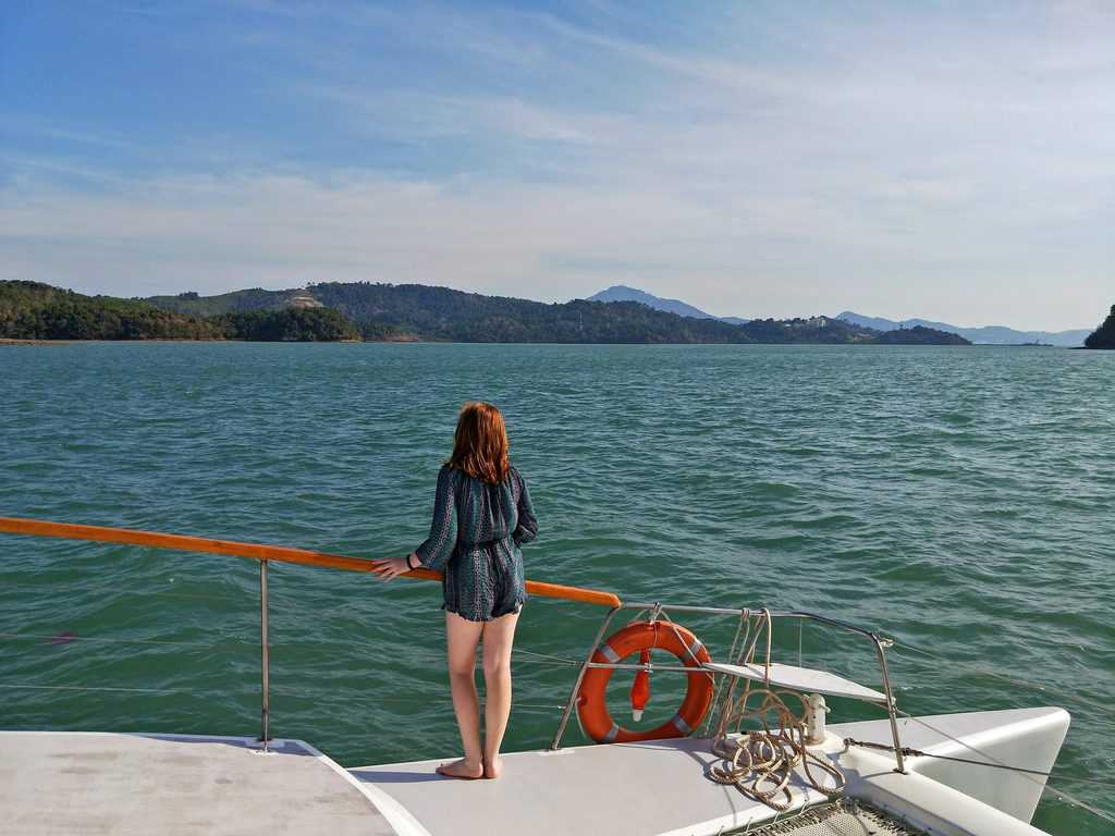 a teenager on boat cruise in Langkawi during their family vacation in Asia