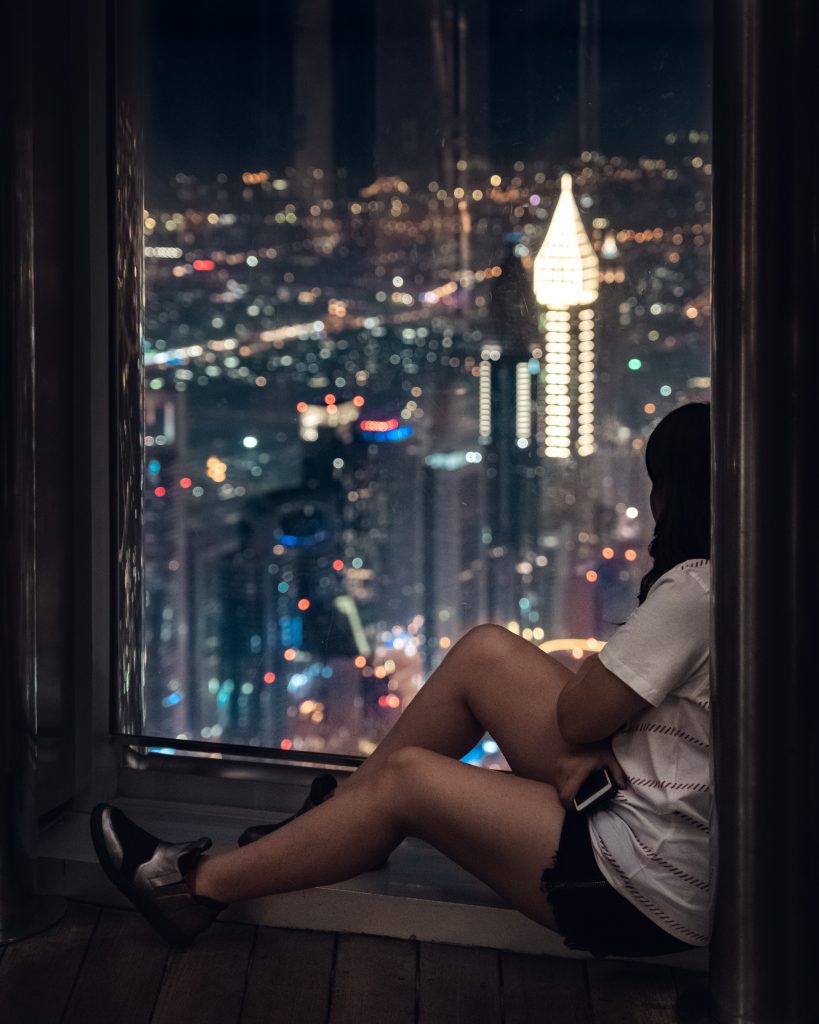 sitting on the window ledge looking at the dubai skyline