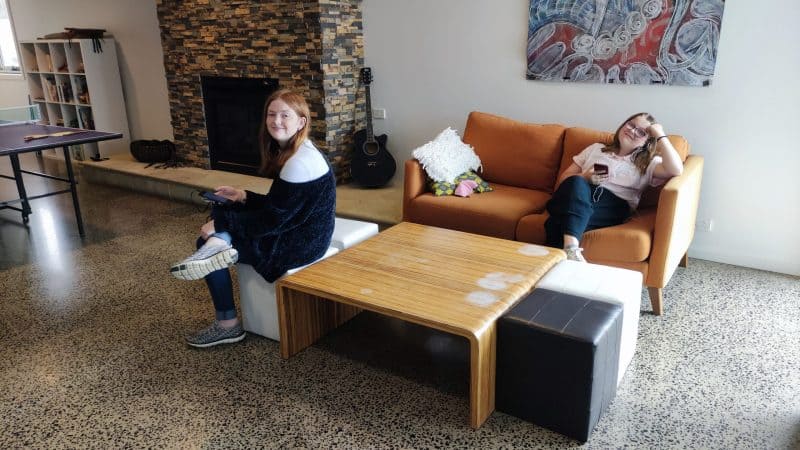 2 teenagers lounging in a hostel