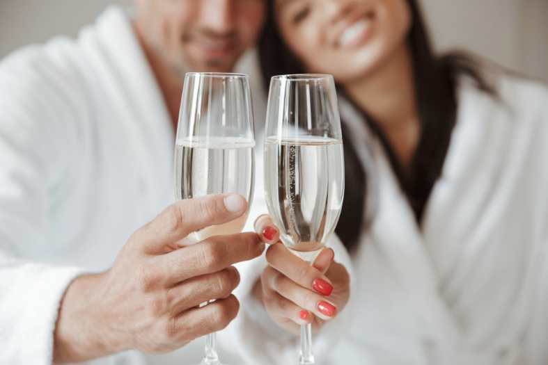 a couple sharing some wine in a hotel room