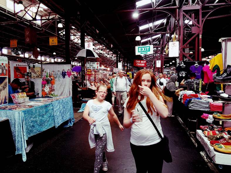 Two teenagers in Melbourne exploring the Queen Victoria Market