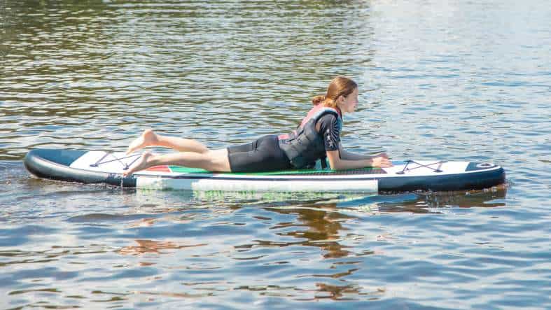A teenage girl in Chicago on a stand up paddle board