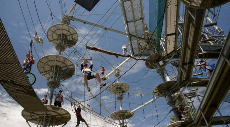 Teens on a high ropes course at west beach in Adeliade