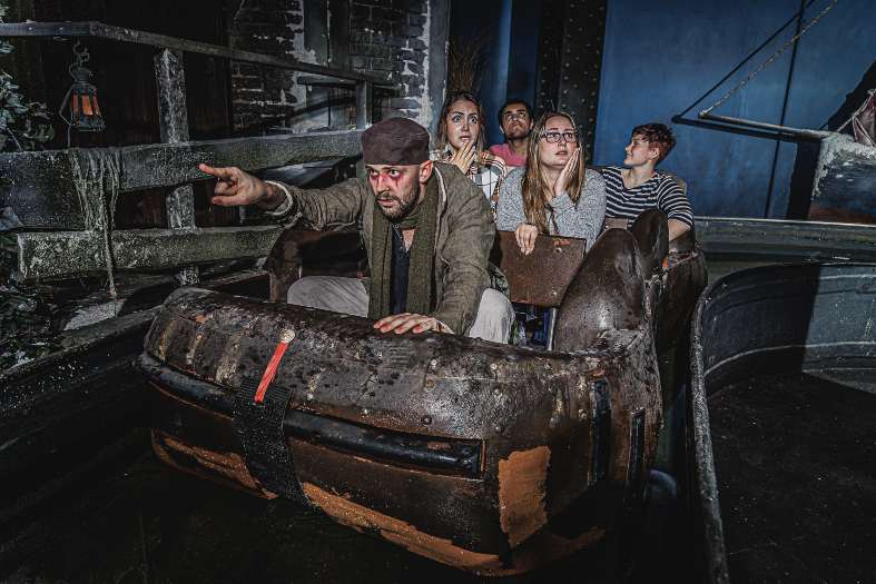 Sitting in a boat on an interactive ride at the London Dungeons