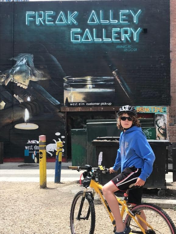 a teenage on a bike checking out freal alley in Boise