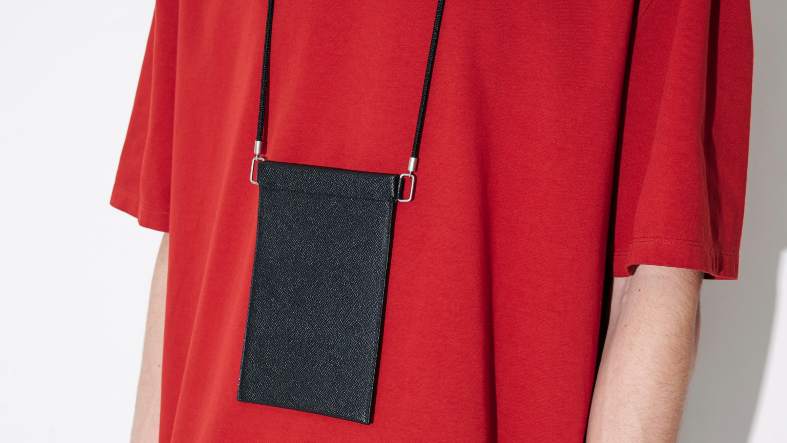 a teenage boy wearing a neck wallet