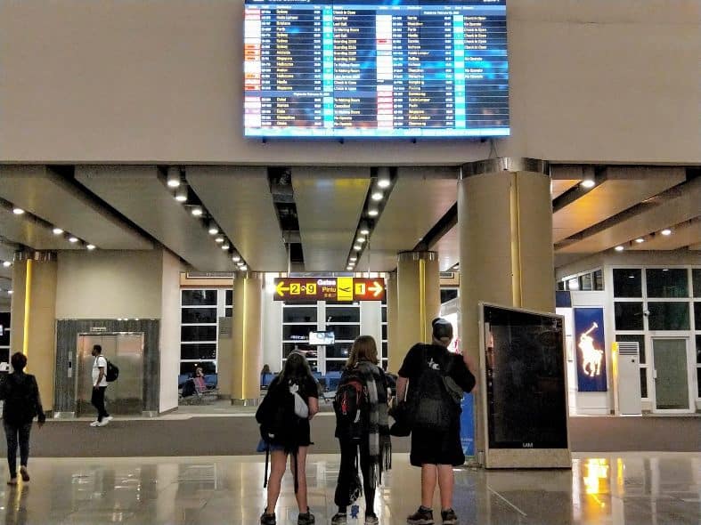 Checking the flights boards for departures and cancellation at Bali airport