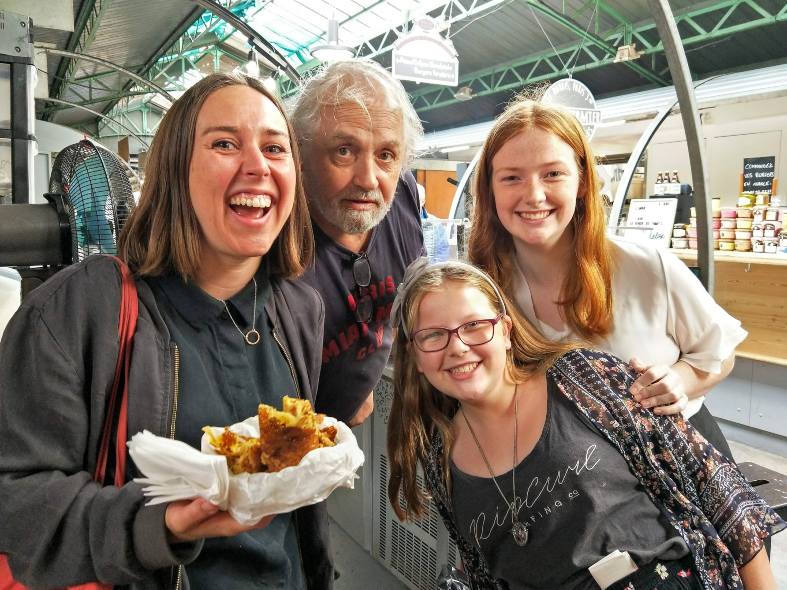 a family enjoying a guided food tour on a Devour Food Tour in Paris