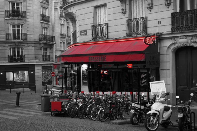a picturesque Parisian street, adorned with elegant architecture, colorful facades, and quaint cafes