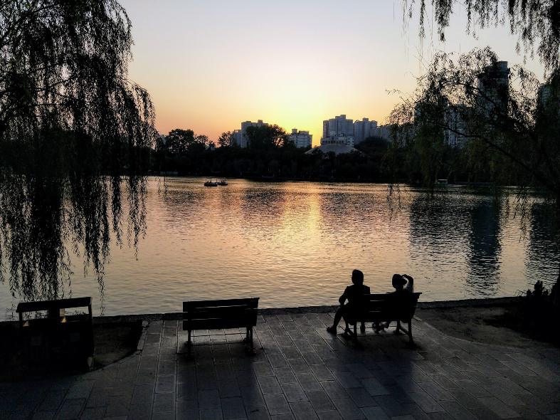 Sitting by a lake enjoying a summer sunset in Xian
