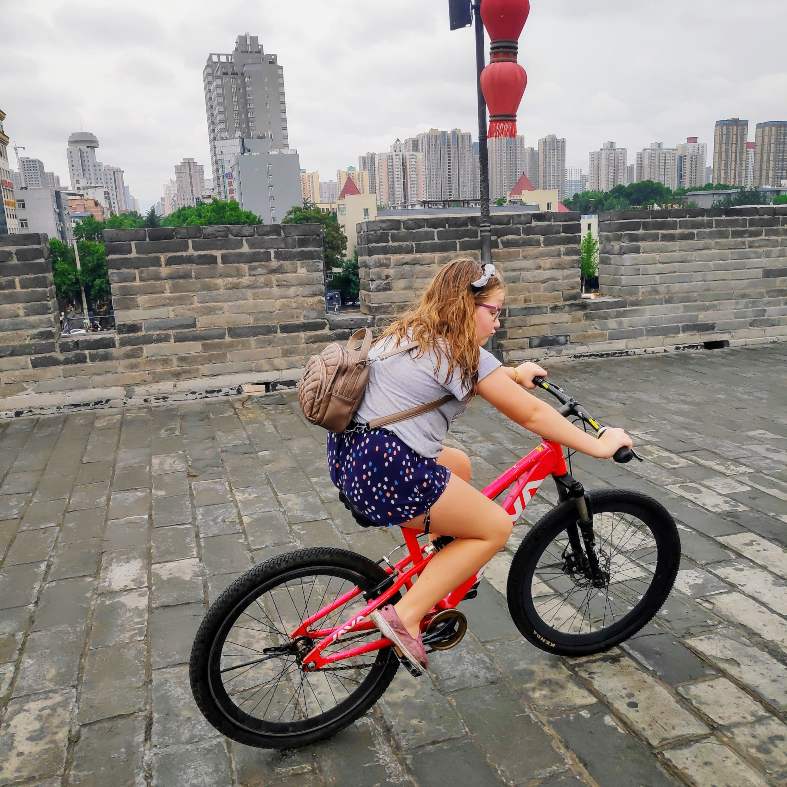 A teenager riding a bike in the Xi'an city walls