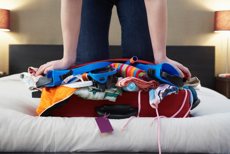 a suitcase overfilled with stuff for long term travel planning