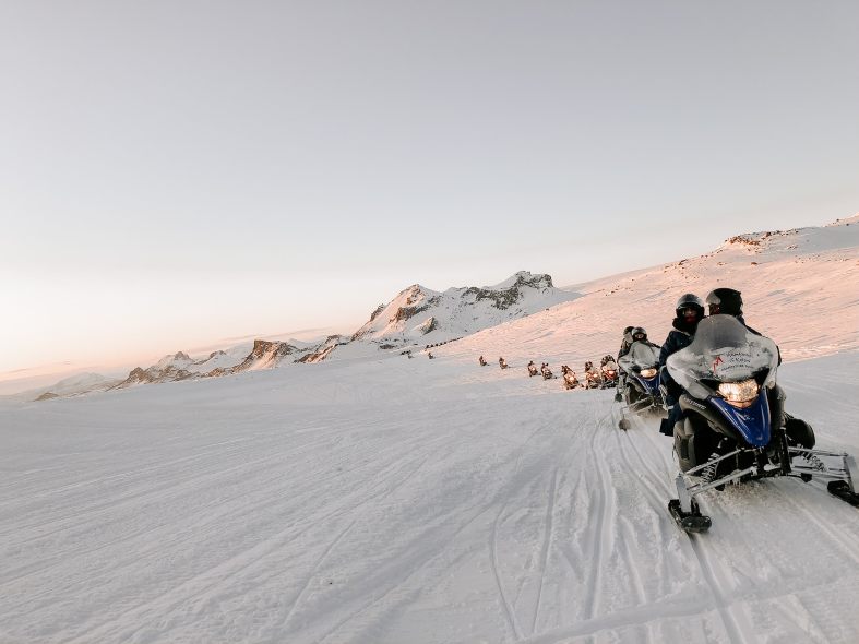 a line of snow mobiles in ice;and