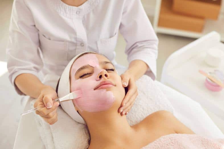 a teenage girl at a day spa recieving a beaty treatment