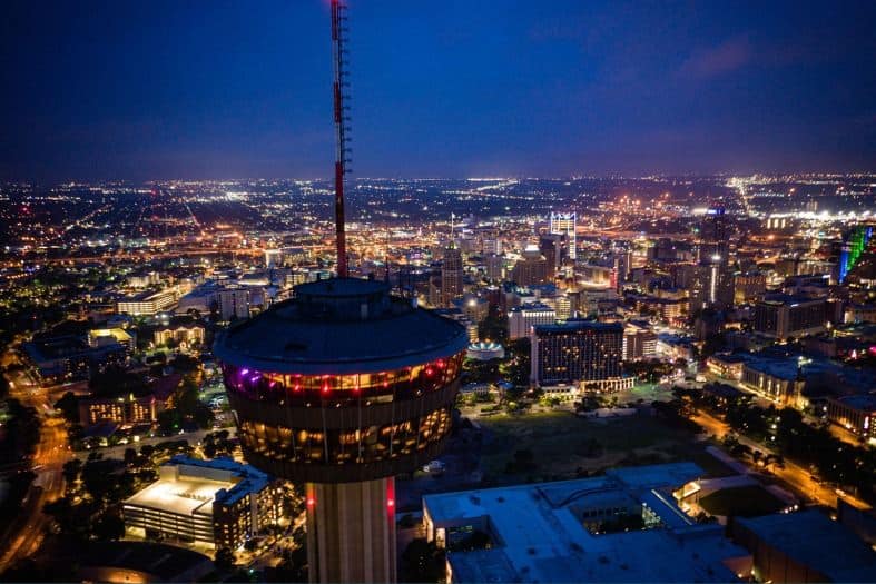 The tower of Americas shining brightly at night in San Antonio.