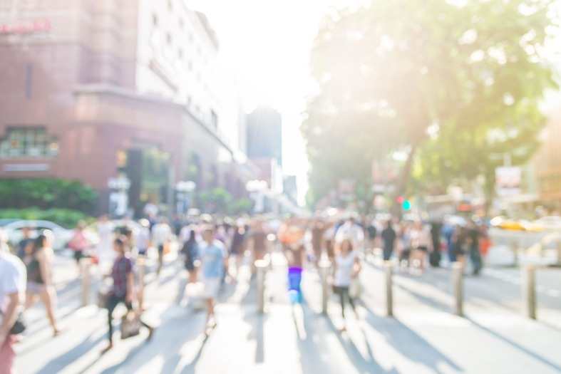 Pedestrians strolling along the bustling sidewalks in Singapore's famous Orchard Road