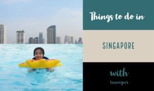 a girl swimming in a rooftop pool in Singapore
