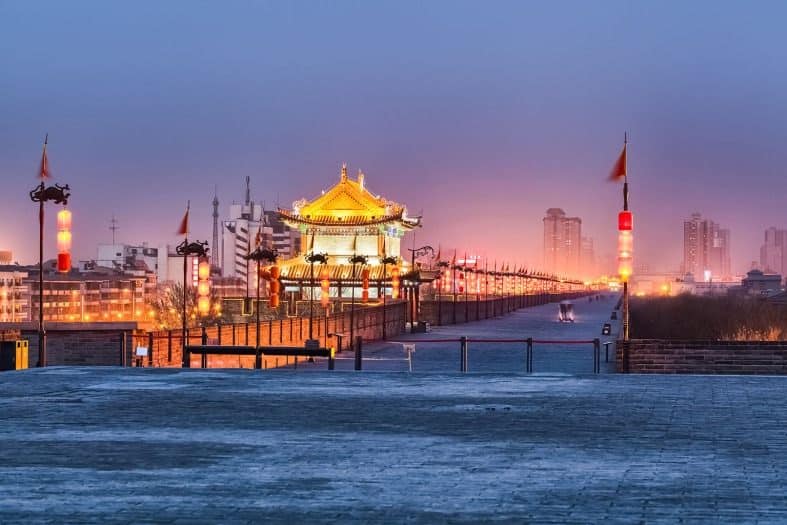 The Xian city wall at night time with city lights in the background