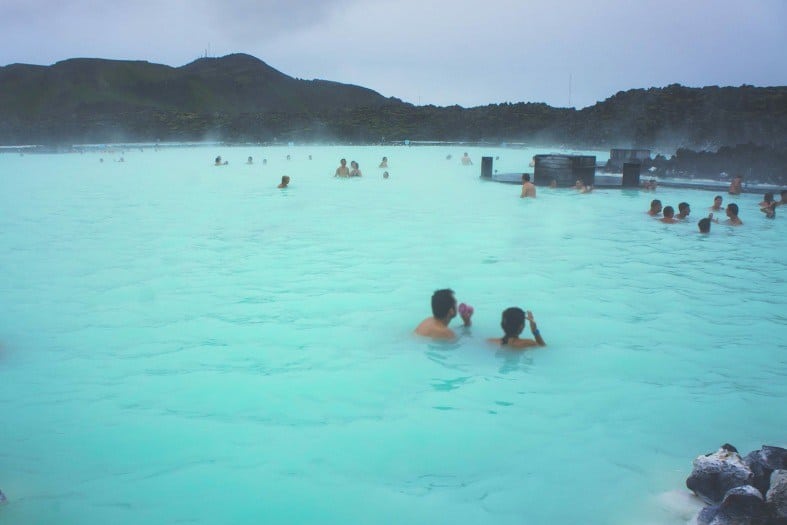 people enjoying the warm blue waters of the blue lagoon Iceland